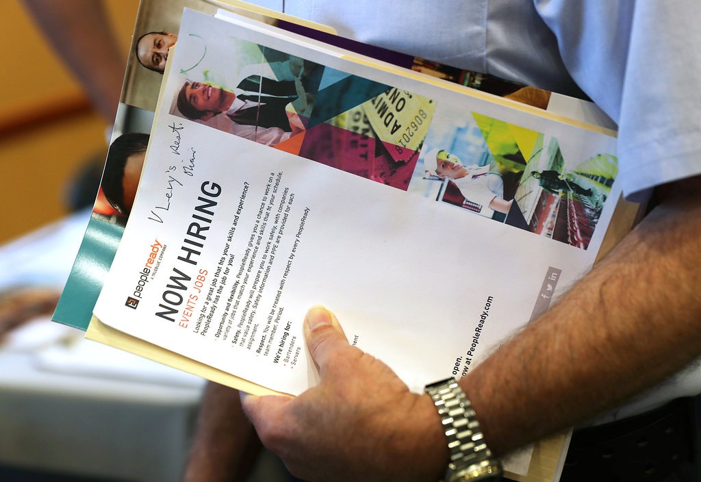 An attendee at a job fair in Miami last month. An improving labor market has lifted wages and left more Americans with jobs, but many remain on the edge financially.